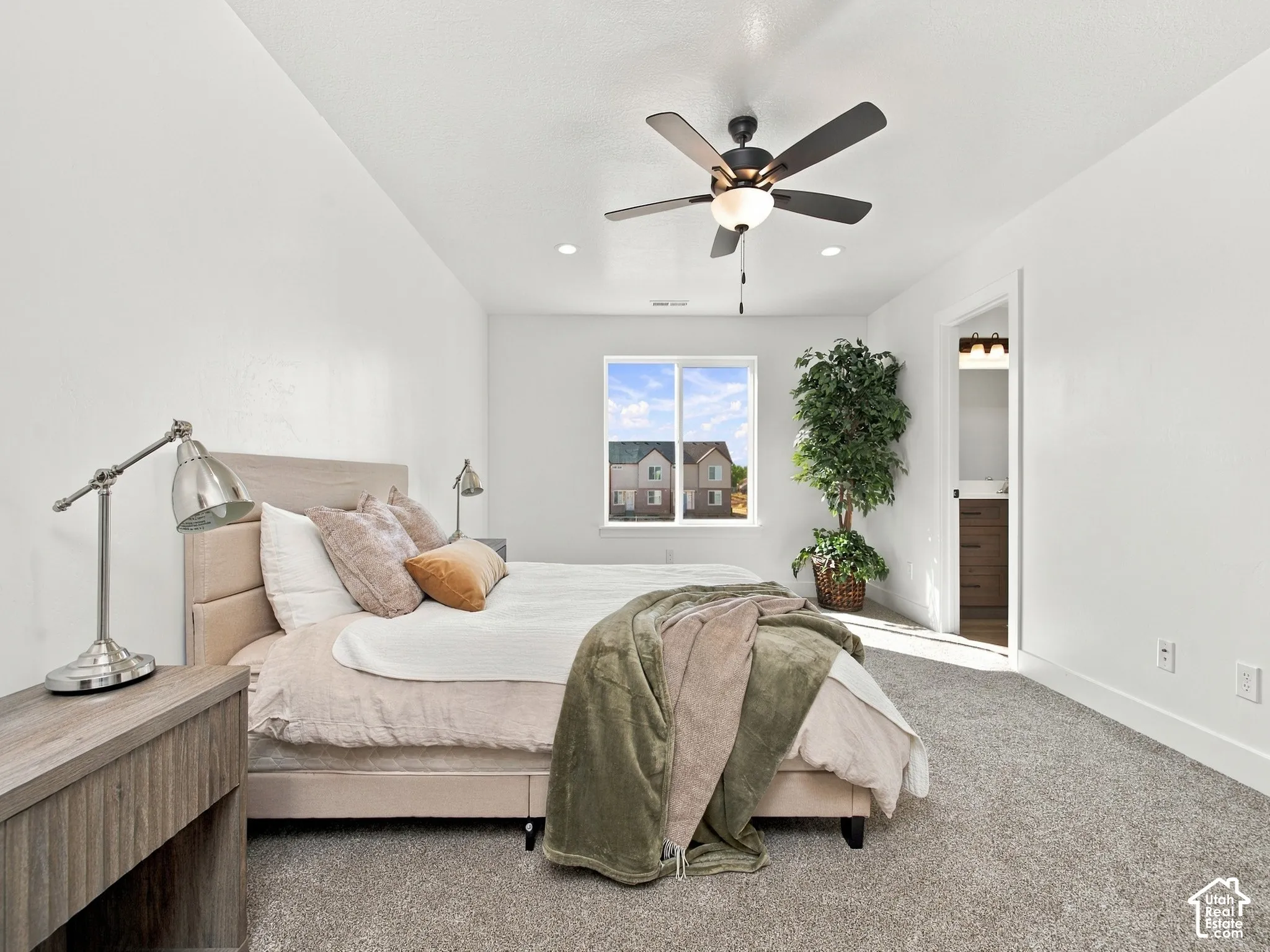 Spacious room featuring a ceiling fan, recessed lighting, and a large window