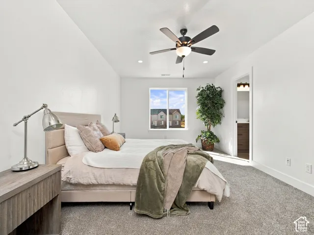 Spacious room featuring a ceiling fan, recessed lighting, and a large window