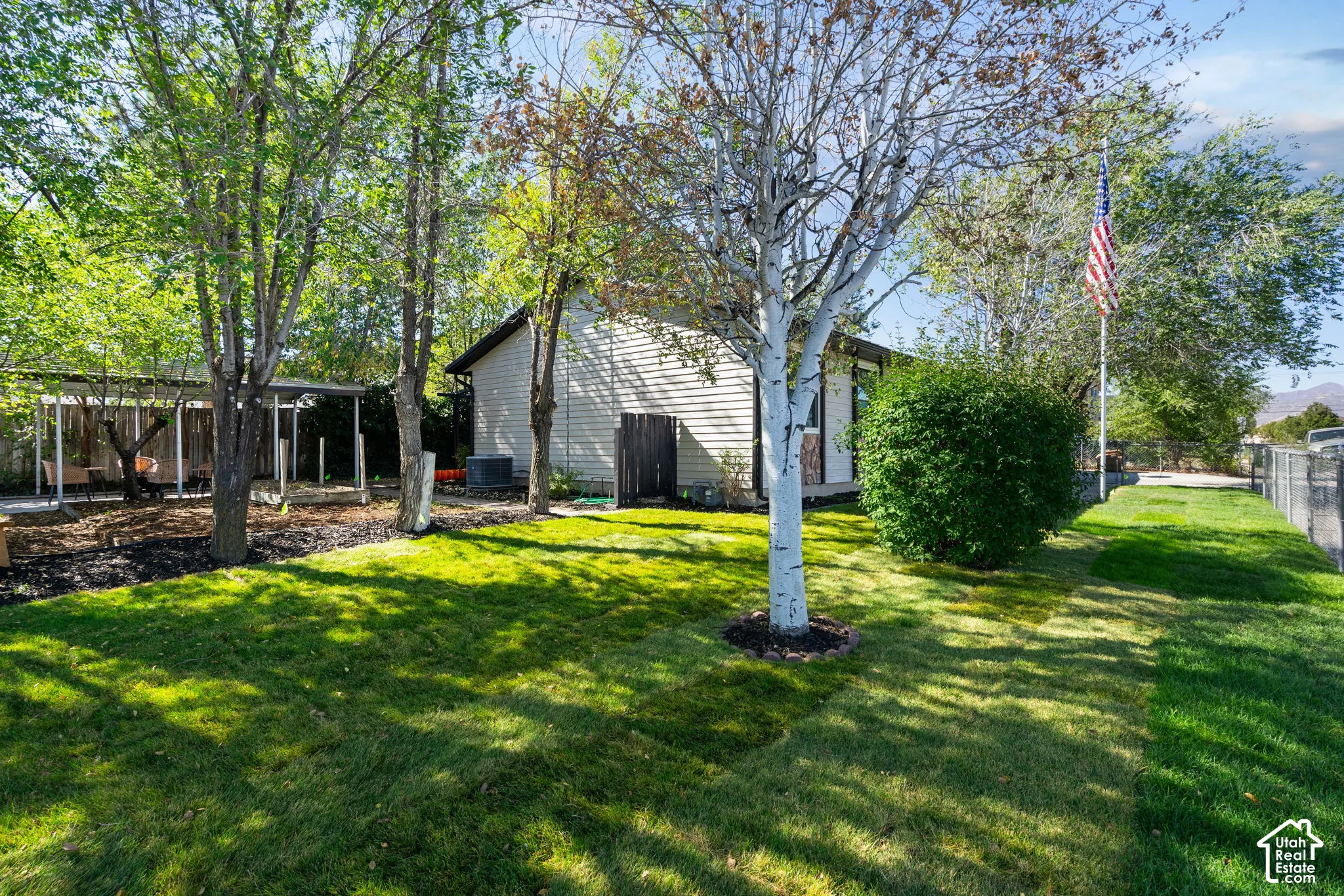 New sod and sprinklers featuring mature trees, garden area, fully fenced and a dedicated covered carport /patio area