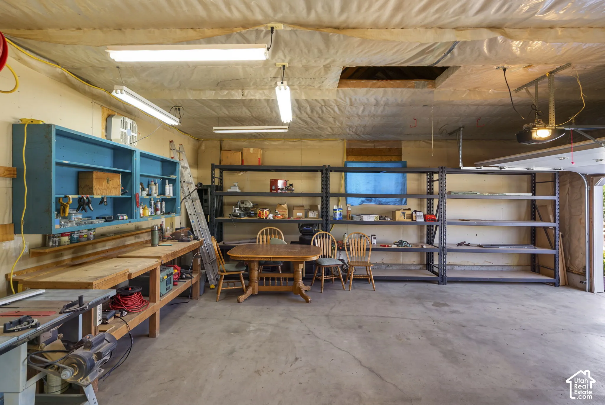 Oversized garage with workbench and built-in shelving.