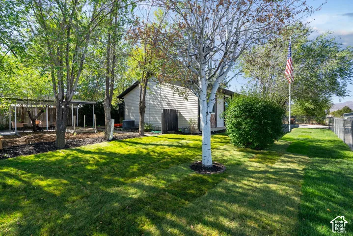 New sod and sprinklers featuring mature trees, garden area, fully fenced and a dedicated covered carport /patio area