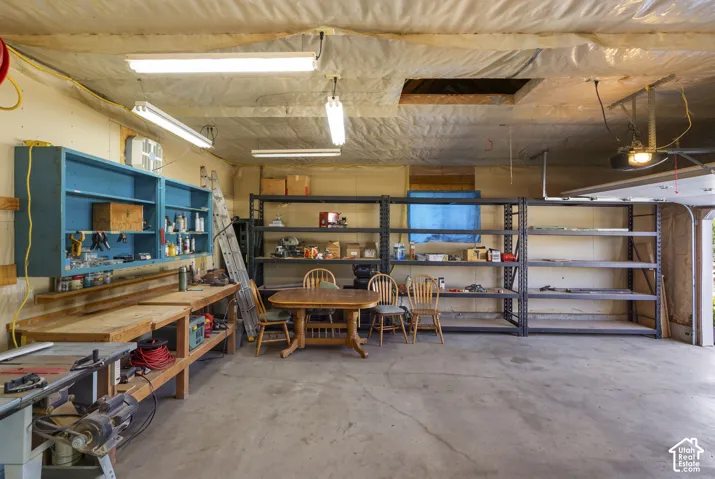 Oversized garage with workbench and built-in shelving.