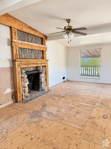Stone-clad fireplace with a wood mantle and slate tile accents - NO Flooring