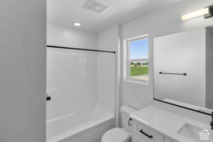 White single-piece bathtub and shower combination with black hardware
