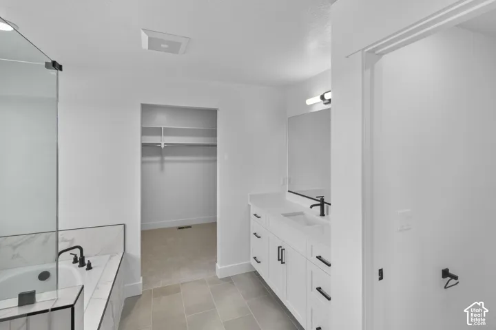 White vanity with dual sinks, quartz countertop, and matte black fixtures