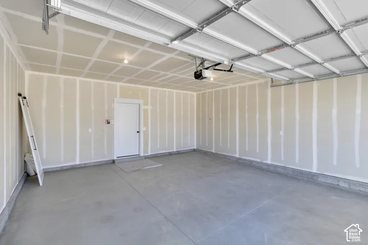 Concrete flooring, finished drywall, overhead lighting, garage door opener mechanism