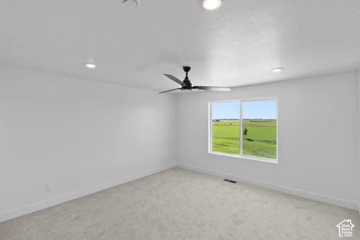 Recessed lighting, ceiling fan, white trim, and a large window