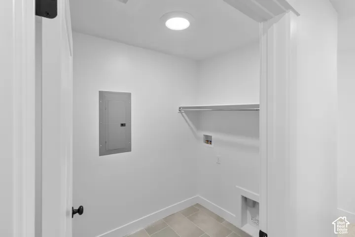 Recessed ceiling light, wall-mounted electrical panel, integrated hanging rod, and utility hookups