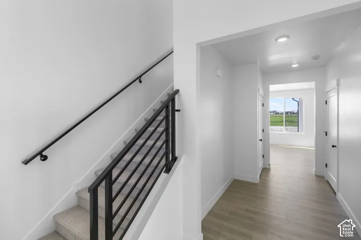 Staircase with black metal horizontal balusters and a wall-mounted handrail