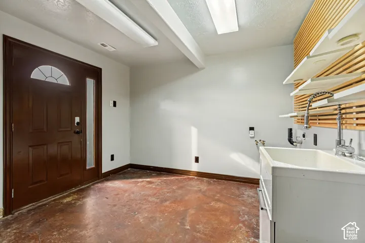 Dark wood entry door with an arched transom window and sidelight