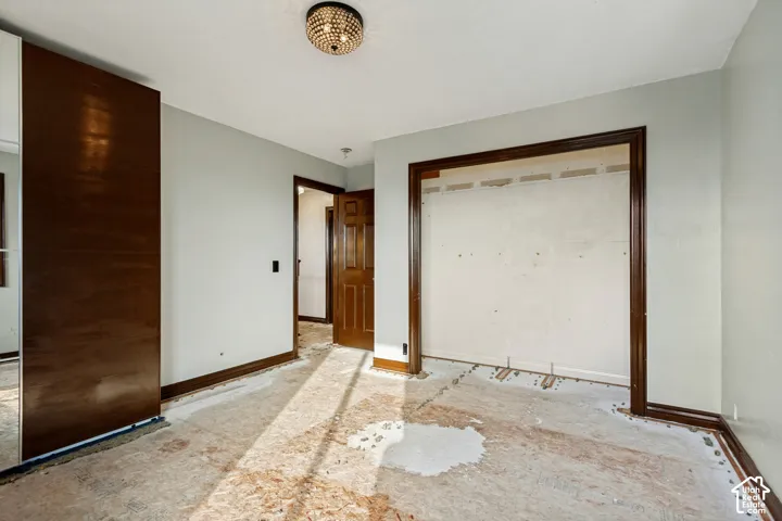 Recessed ceiling light fixture, wood-paneled door, and built-in closet space