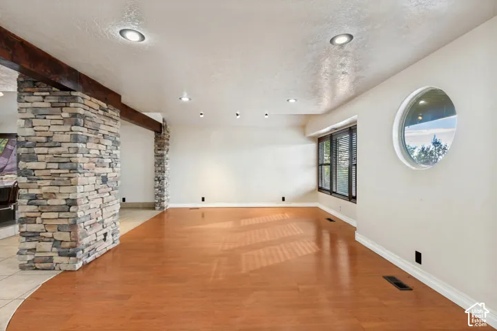 Wood-finish flooring with a decorative stone pillar