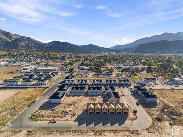 New construction development featuring multiple townhome-style residences and a mountain backdrop