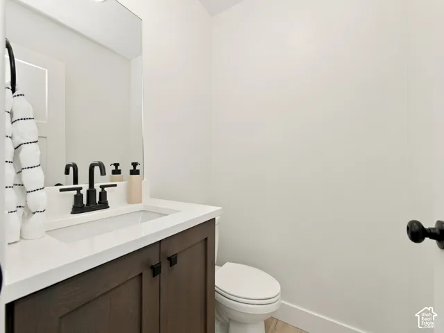 Dark wood-finish vanity with a white countertop and integrated sink