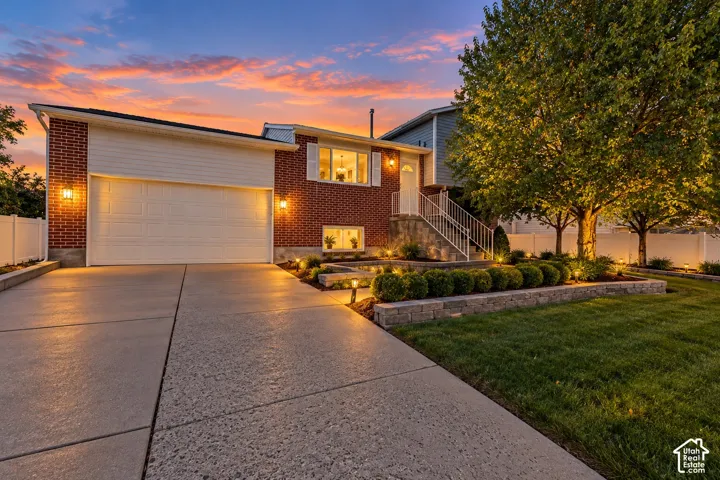 Brick exterior with white siding and attached two-car garage