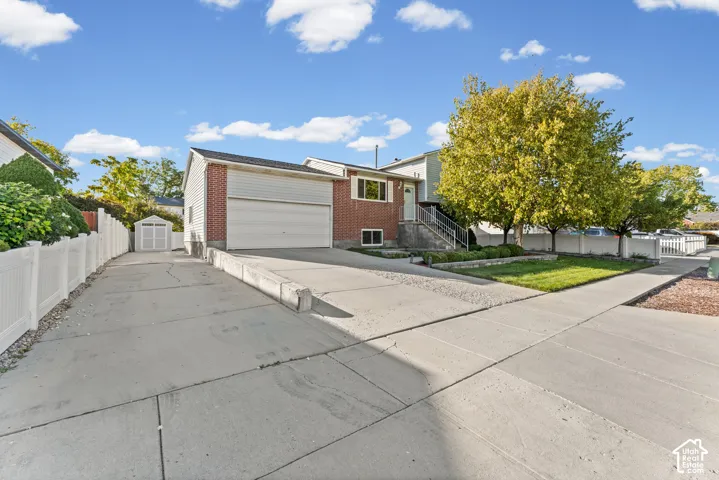 Brick and siding exterior with an attached garage