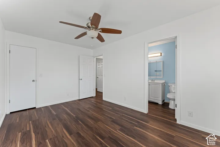 Wood-finish flooring, white walls, and a ceiling fan with integrated lighting