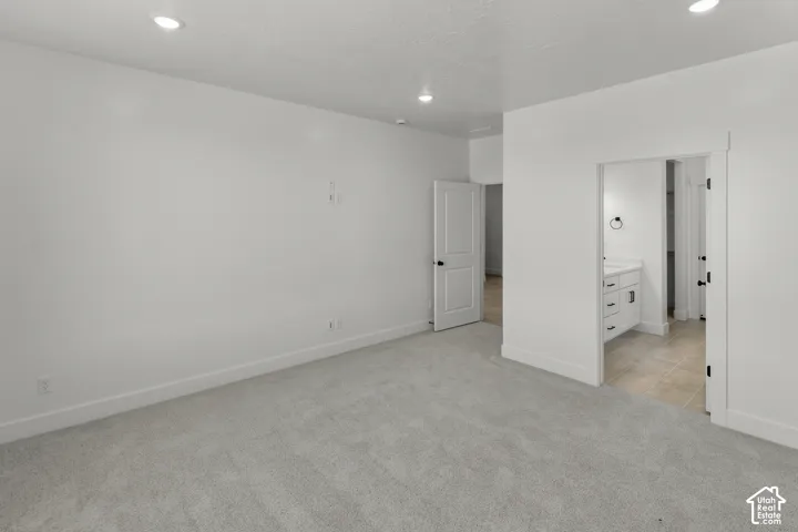 Bright interior with recessed lighting, plush carpet flooring, white walls, and white trim