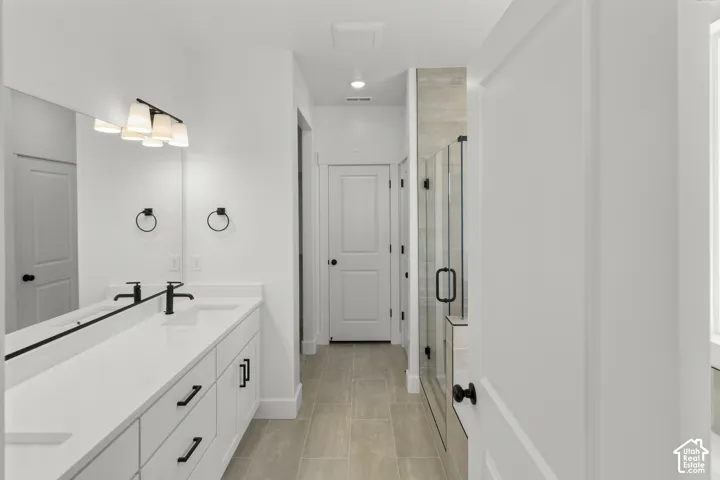 Dual vanity with white cabinetry and black hardware