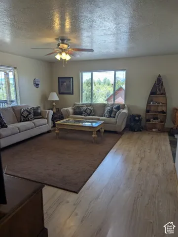 Spacious Living Room - Wood-finish flooring throughout, ceiling fan & beautiful wood trim & doors!