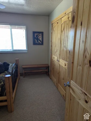 Bedroom with ceiling fan & custom wood trim/closet doors