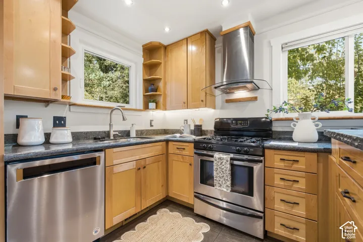 Kitchen with wood cabinetry, granite work surfaces with seating, and tile flooring