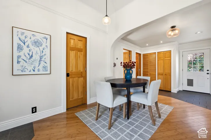 Dining area with pendant lighting and hardwood floors