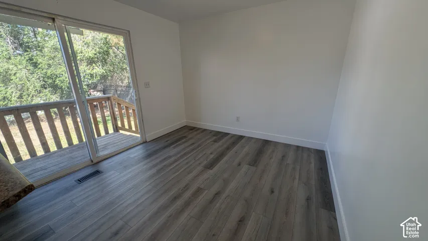 Wood-finish flooring with white baseboards