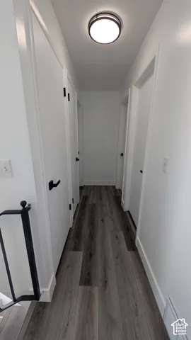 Hardwood-finish flooring with white baseboards and white walls