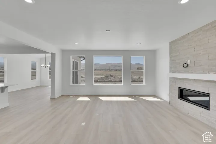 Recessed lighting and light wood-finish flooring throughout
