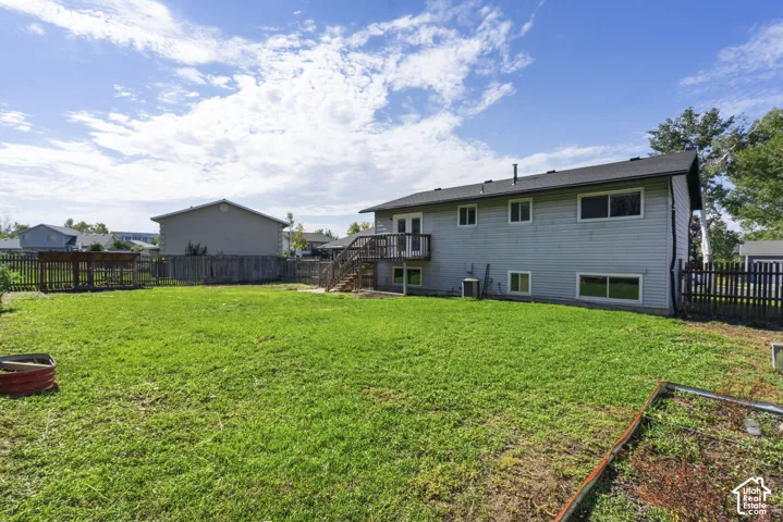 Expansive green lawn with a wood fence perimeter