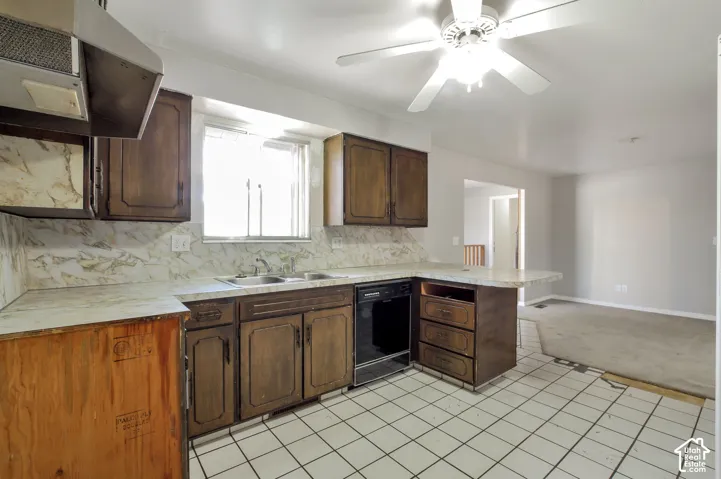 Kitchen featuring wood cabinetry, a dual-basin stainless steel sink, a built-in dishwasher, and white square tile flooring