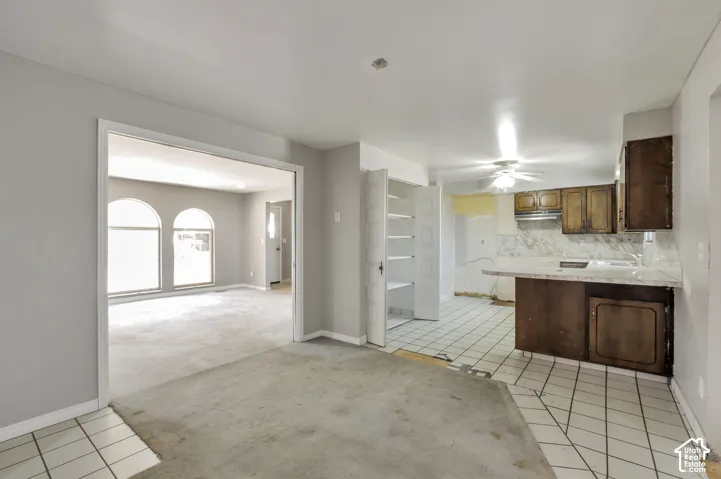 Kitchen area with tile flooring and a built-in pantry