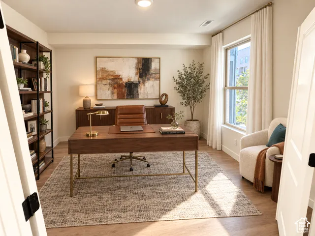 Wood-finish flooring throughout, built-in shelving unit, and recessed lighting