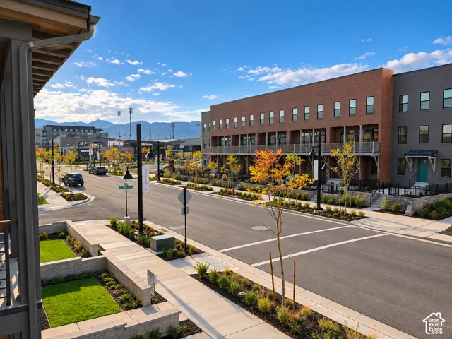 Brick and stucco multi-story buildings featuring balconies and landscaping