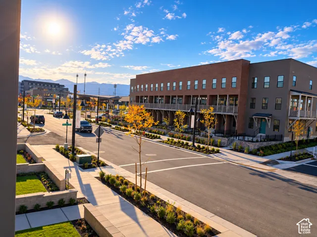 Modern townhomes with brick and stucco exteriors, featuring individual balconies and street-level entrances