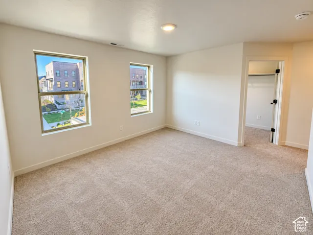 Carpeted flooring, recessed lighting, and dual windows