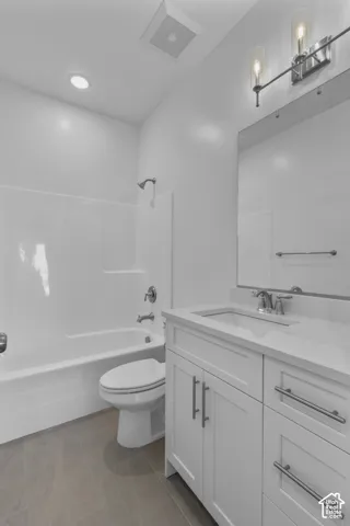White vanity with a rectangular undermount sink, a chrome faucet, and brushed nickel hardware