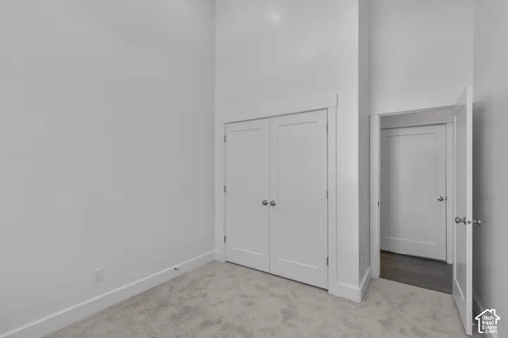 White walls, neutral carpet, and white trim
