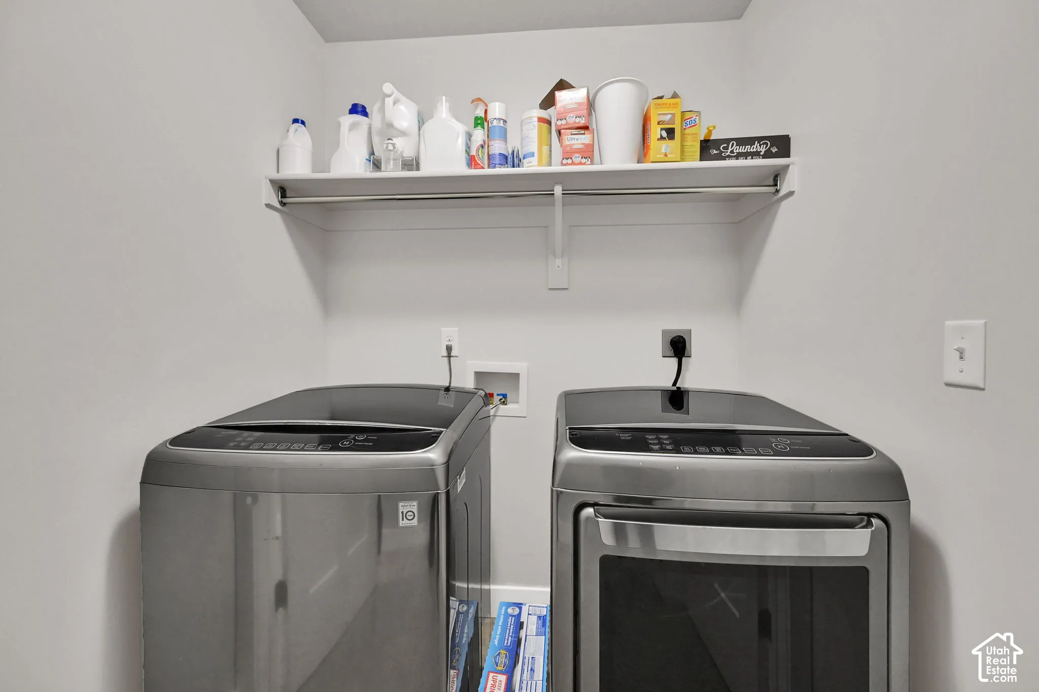 Utility space featuring a built-in shelf and a clothing rod