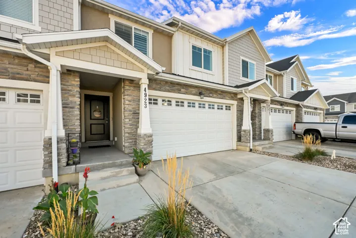 Stone veneer and siding exterior with a covered entry