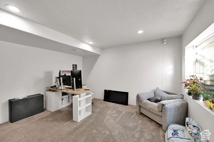 Recessed ceiling lighting, carpeted flooring, and a window with a deep sill