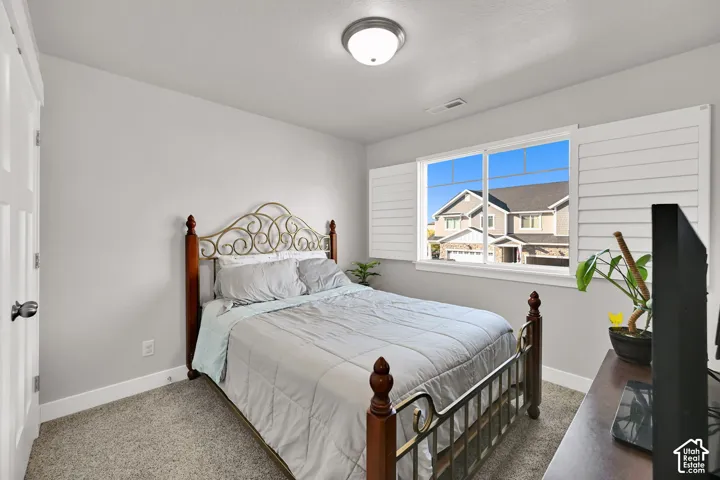 Window with white louvered shutters, flush mount ceiling light fixture, and light gray wall paint