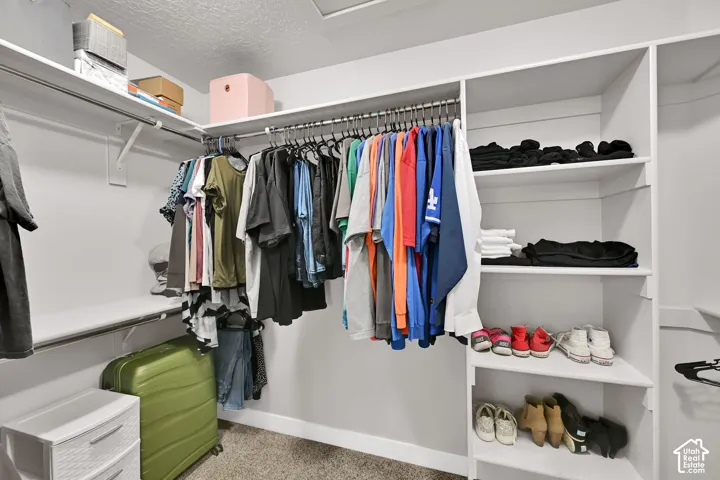 Integrated closet system featuring multiple hanging rods, overhead shelving, and built-in shelving units