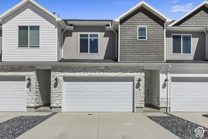 Stone veneer facade with white siding accents