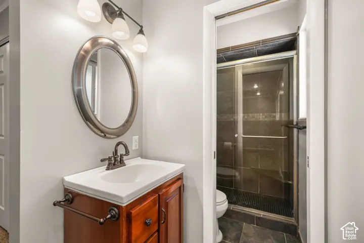 Wood-finish vanity with an integrated sink and bronze-finish faucet