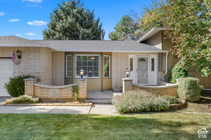 Brick exterior with a gabled roof and attached garage