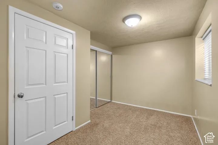 Neutral-toned walls complement plush carpet flooring
