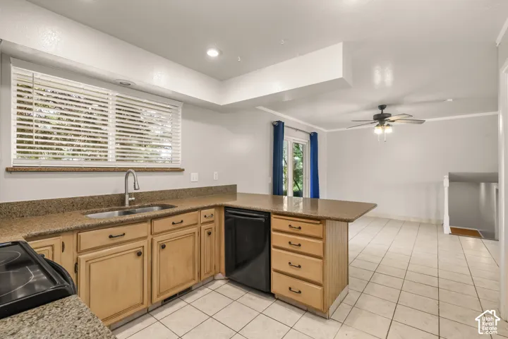 Kitchen featuring wood cabinetry, a stainless steel sink, black appliances, and stone-finish countertops