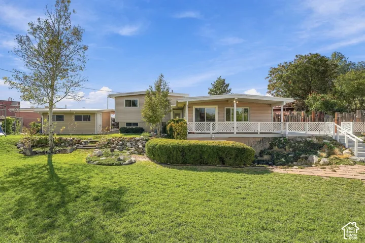 Expansive lawn with mature trees and stone retaining walls